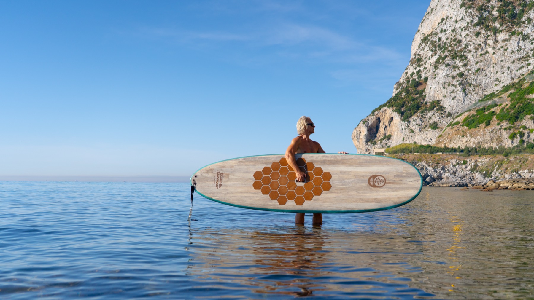 The founder holding the Agave 10 in the sea beneath the cliffs of Gibraltar